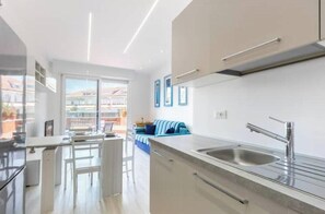 Een moderne keuken met een eethoek, een bank en uitzicht op de omgeving.