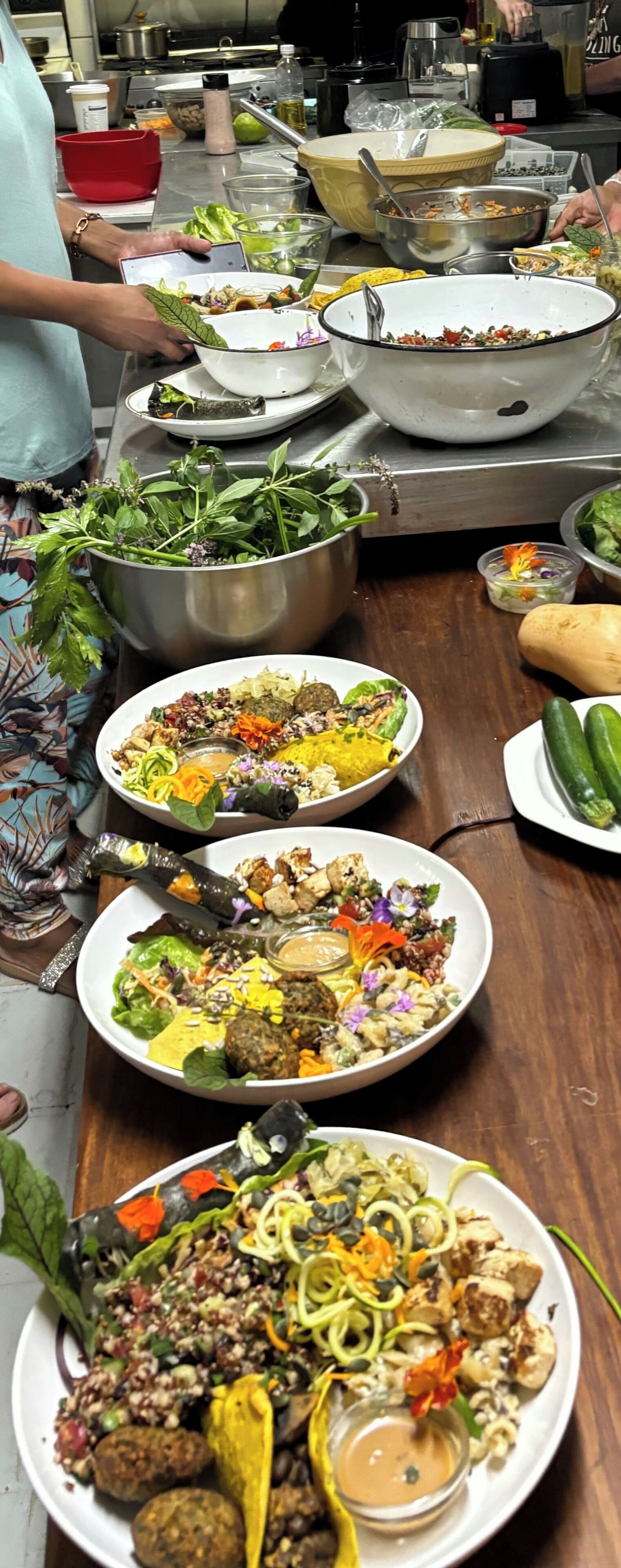 A buffet table with various dishes, including salads, meats, and vegetables.