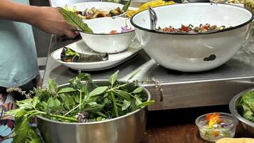 A buffet table with various dishes, including salads, meats, and vegetables.