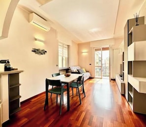 Un interior moderno con comedor, sofá y balcón.