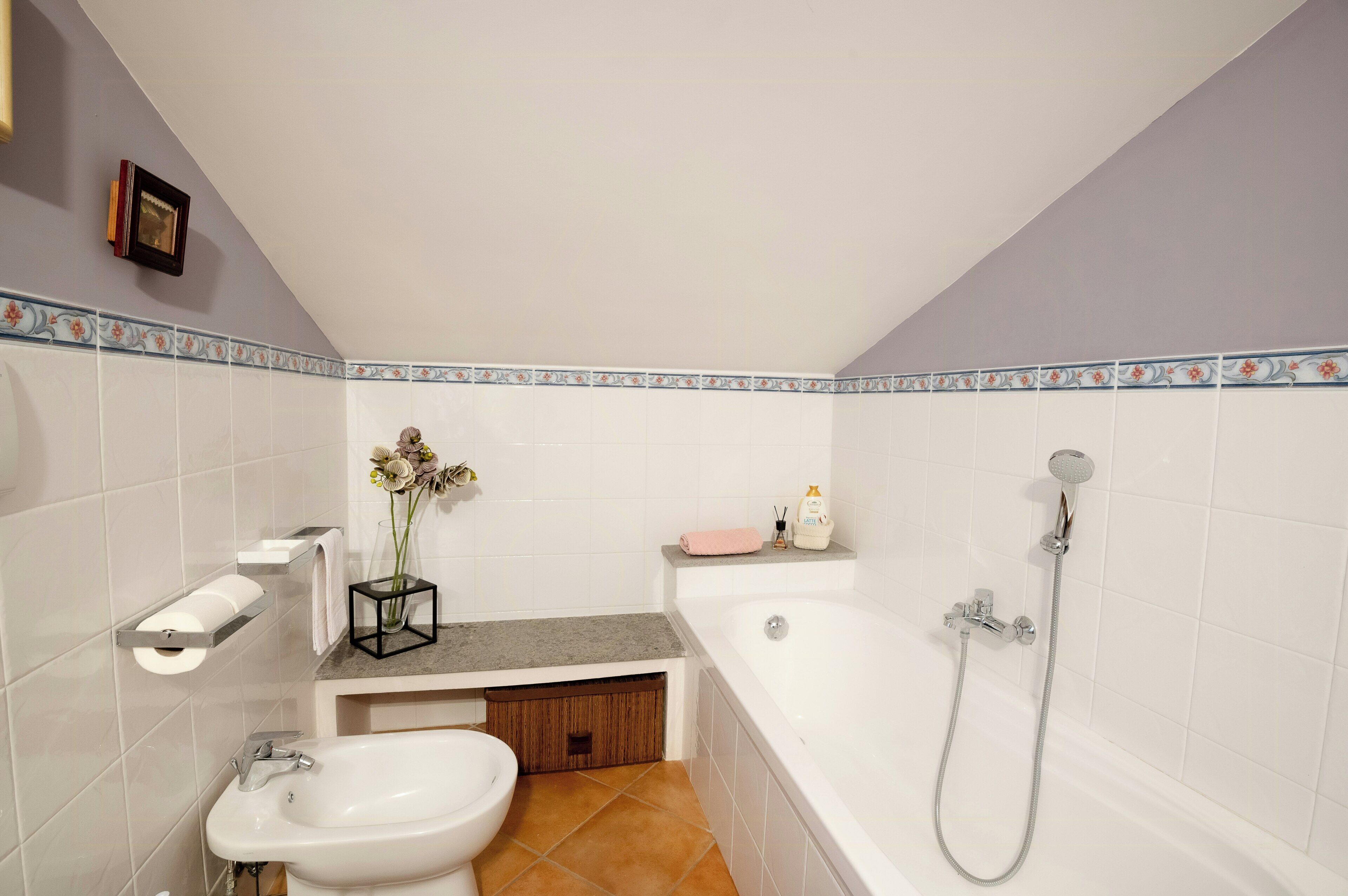 A bathroom with a bathtub, a sink, a vanity, and a shower.