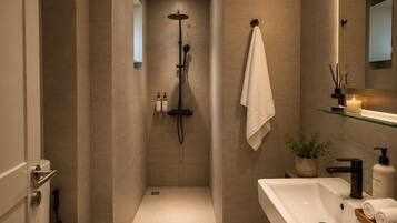 A modern bathroom with a bathtub, toilet, and sink.