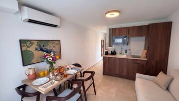 A modern kitchen with dark wood cabinets, a built-in microwave, and a countertop with a sink.
