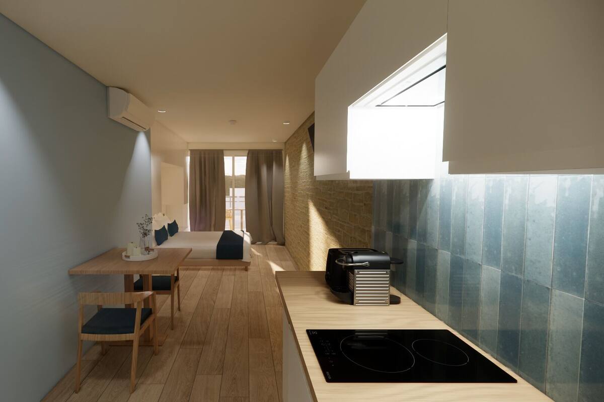 A modern kitchen with a dining area, a built-in stove, and a view to the outside.