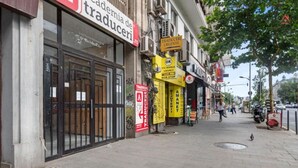 A street with storefronts, including a translation service and a non-stop exchange. - Beautique Apartament Panoramic View | Central (Bucharest)