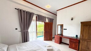 A bedroom with a bed, a wooden desk, a mirror, and a wardrobe. - The Reef Resort Nilaveli - Trincomalee (Nilaveli)