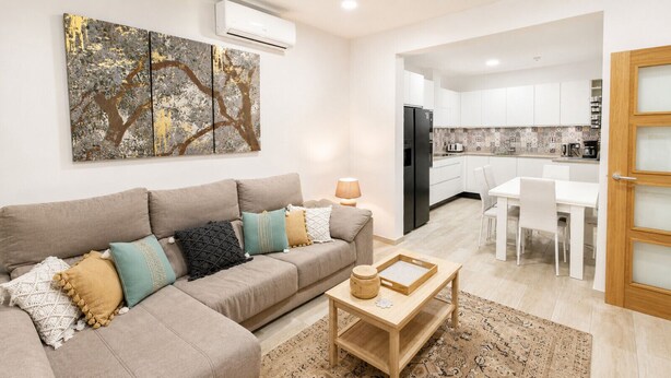 Ein Wohnzimmer mit einer Couch, einem Couchtisch und einem Gemälde an der Wand.