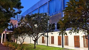 A building with a modern architectural style, featuring a covered walkway and a well-maintained lawn. - NN Beach Resort Nilaveli (Trincomalee)