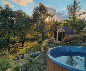 A cylindrical wooden structure with a glass door, a pool, and surrounding greenery. - Apartment in a 16th century farmhouse (Monteverdi Marittimo)
