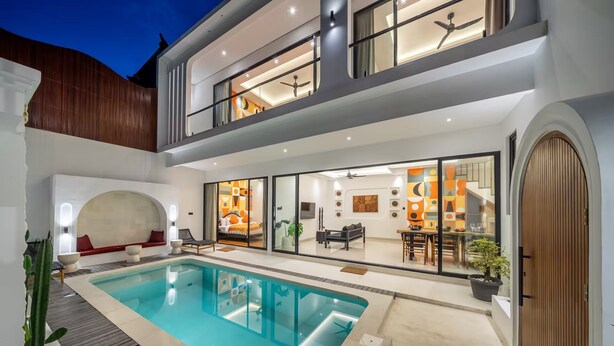 A modern two-story house with a swimming pool, a dining area, and a living room with a large window. - Alisa 3 Villa (Kerobokan)
