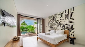 A modern bedroom with a wooden bed, a large wall mural, and a view of a pool and greenery. - Alisa 4 Villa (Kerobokan)