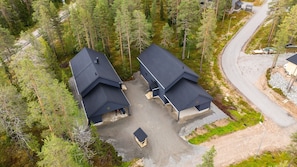 A residential area with two houses, each with a dark roof and a small attached garage.