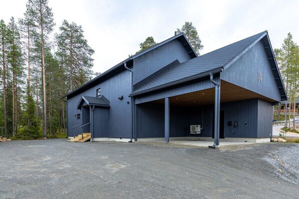A modern building with a large garage and a covered entrance area.