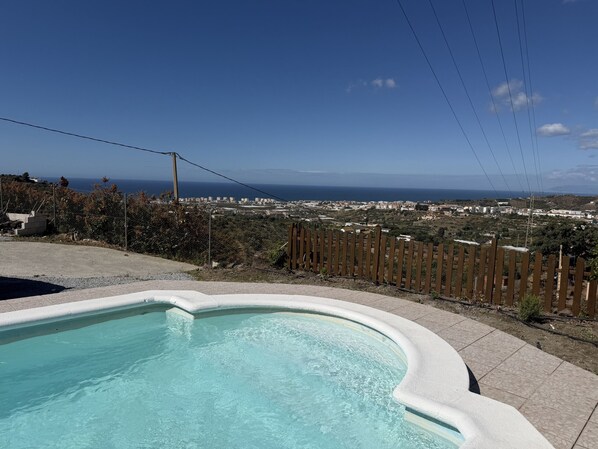 A swimming pool with a view of a coastal cityscape. - Cortijo del Verdial by At Home Costa del Sol (Torrox)