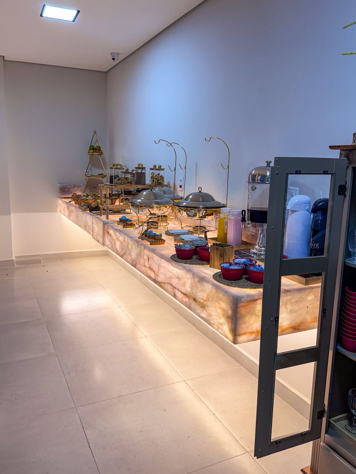 A buffet setup with food items and serving equipment.