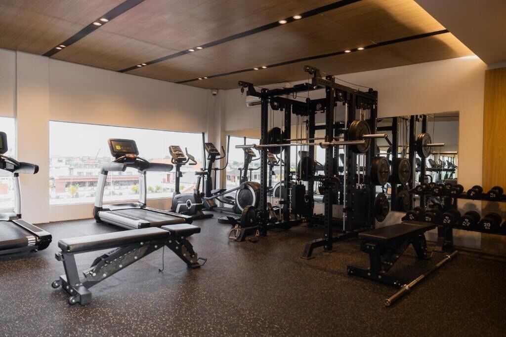 A gym with treadmills, weight machines, and free weights.
