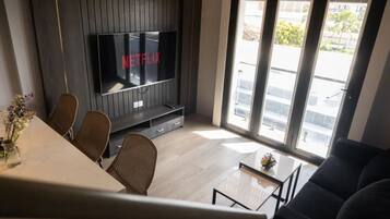 Luxury Apartment, 1 Bedroom, City View | Living area | 50-inch Smart TV with premium TV channels