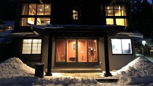 A two-story house with a large front porch, a covered entryway, and a visible interior with a dining area. - Aone Onsen Itto Onsenyado Seigetsu (Kawasaki)