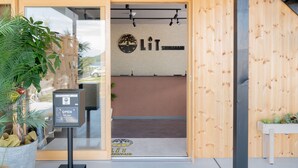 A wooden entrance with a sign reading 'LIT SHINANAMI' and a door leading inside. - LIT Shimanami (Onomichi)