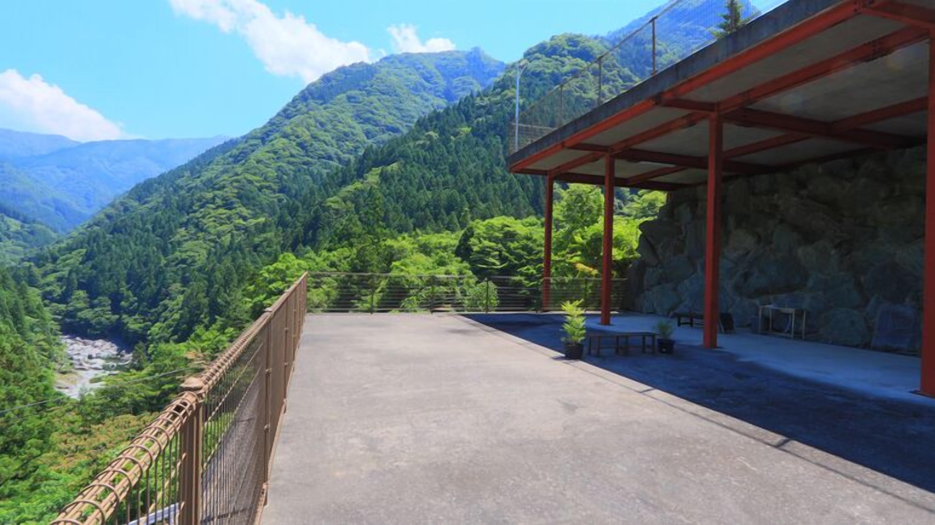 A covered outdoor area with a view of a mountainous landscape.