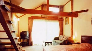 A bedroom with a bed, a desk, a chair, and a staircase. - Shiki no Mori Hotel (Tateshina)