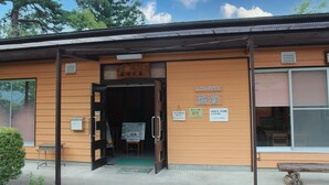 A building with a sign reading 'RESTAURANT' and 'CLUB' on the front. - Jomine Park Campsite (Kamikawa)
