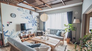 A living room with a sofa, coffee table, TV, and decorative items. - Akiyato Date Dream Date Home (Date)