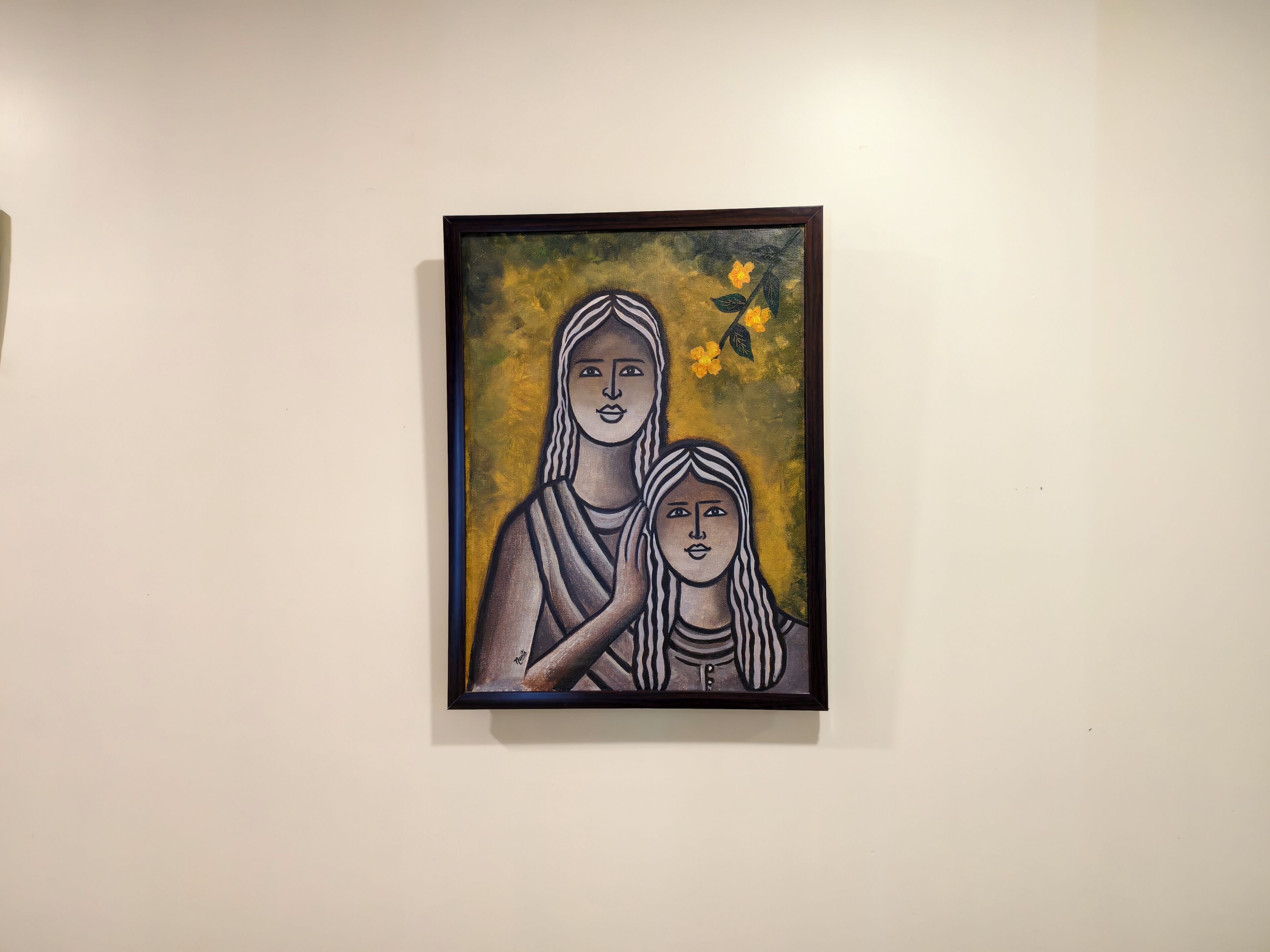 A framed artwork on a plain wall.