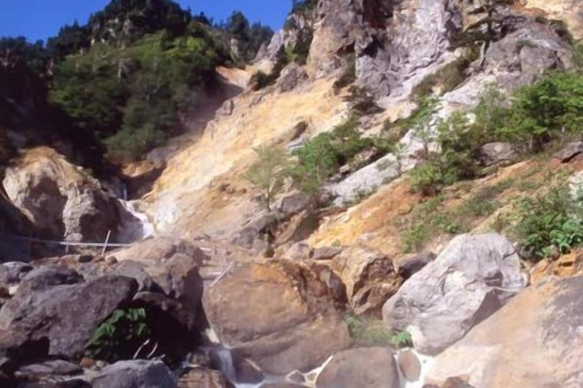 A rocky landscape with a clear stream flowing through.