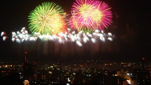 A nighttime cityscape with fireworks. - Ikaho Bekkan (Nagano)
