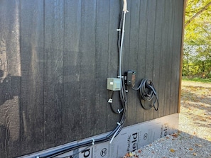 A wooden structure with electrical wiring and a cable connected to a box.