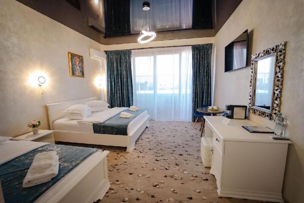Deluxe Triple Room, Balcony | In-room safe, desk, iron/ironing board, free WiFi