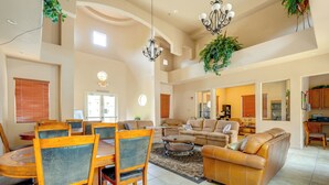 A spacious living room with a dining area, high ceilings, and a kitchen in the background. - Resort-style Pools & Hot Tubs! Mtn-view Mesa Condo (Mesa)