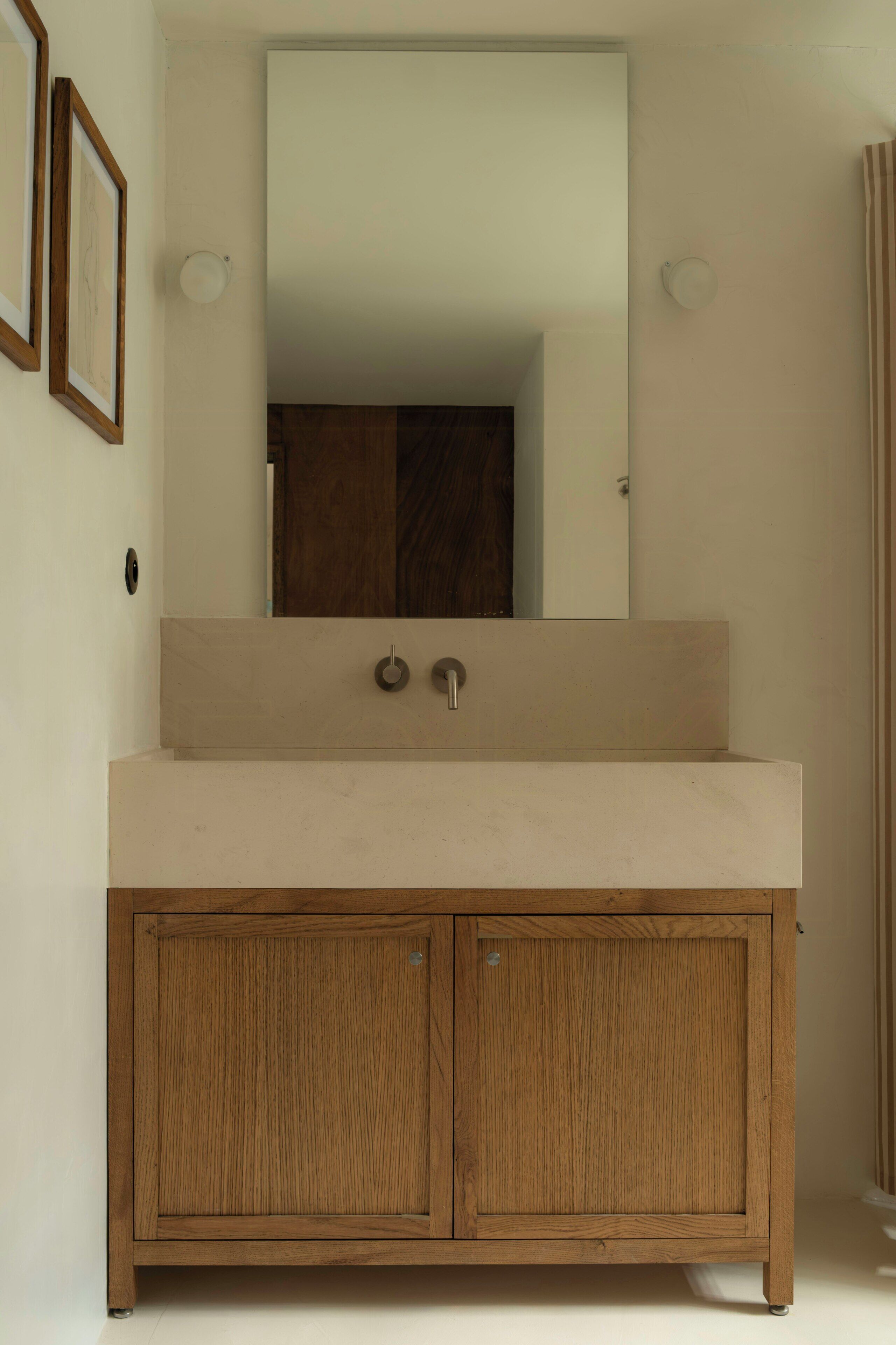 A bathroom with a wooden vanity, a large mirror, and a shower curtain.
