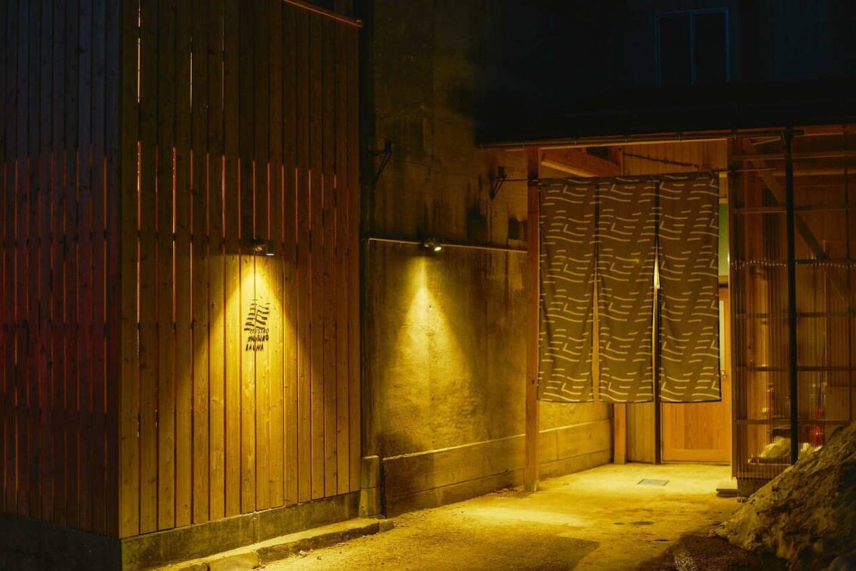 A wooden building with a wooden door and a glass entrance.