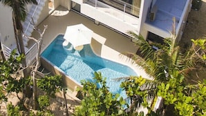 A modern two-story house with a swimming pool, large windows, and a balcony. - The Seven Stars Resort (Ishigaki)