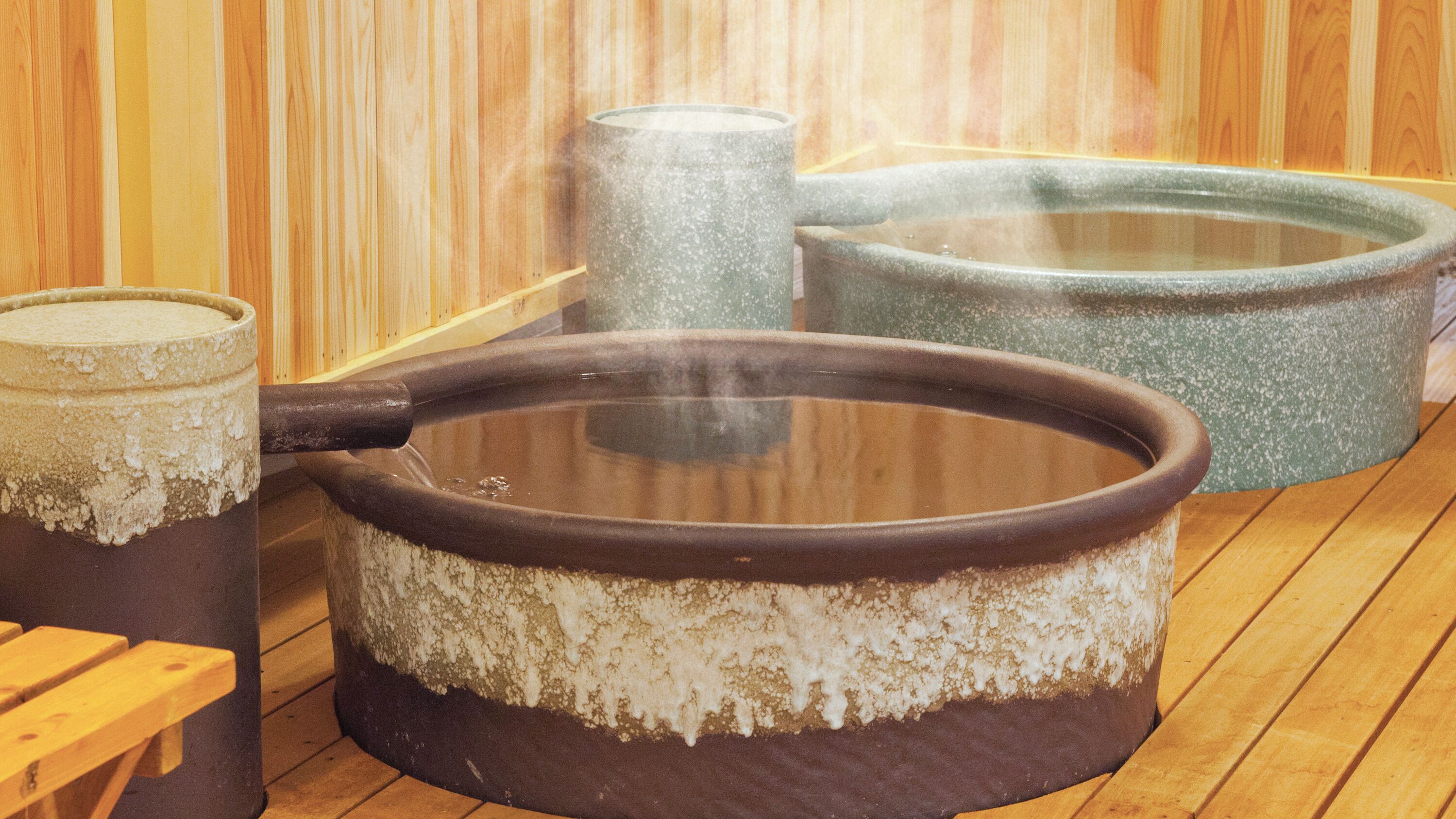 A sauna with stone tubs and benches.