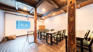 A conference room with a wooden table and chairs, a projector, and a screen displaying text. - Hakone Yumoto Onsen Ryokan Yamatokan (Hakone)