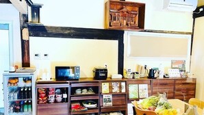 Uma cozinha compacta com geladeira, micro-ondas e armários de madeira.
