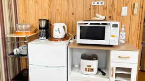 A compact kitchenette with a coffee maker, kettle, microwave, and rice cooker. - Matsue no Sato (Matsue)