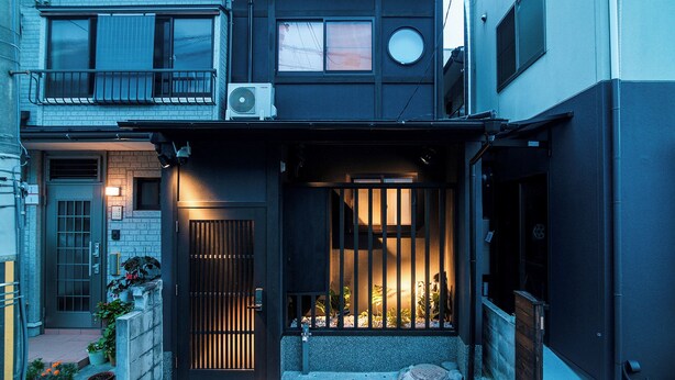 A two-story residential building with a balcony, a small garden area, and a gate. - Kyoran Satsukitei (Kyoto)