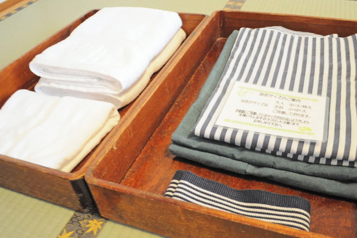 A wooden tray with folded towels and a tag.