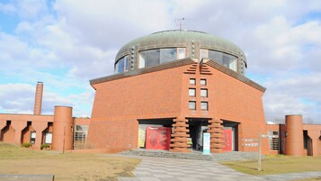 Un edificio de ladrillo con una cúpula y una entrada roja.