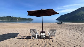 On the beach, sun-loungers, beach umbrellas, beach towels