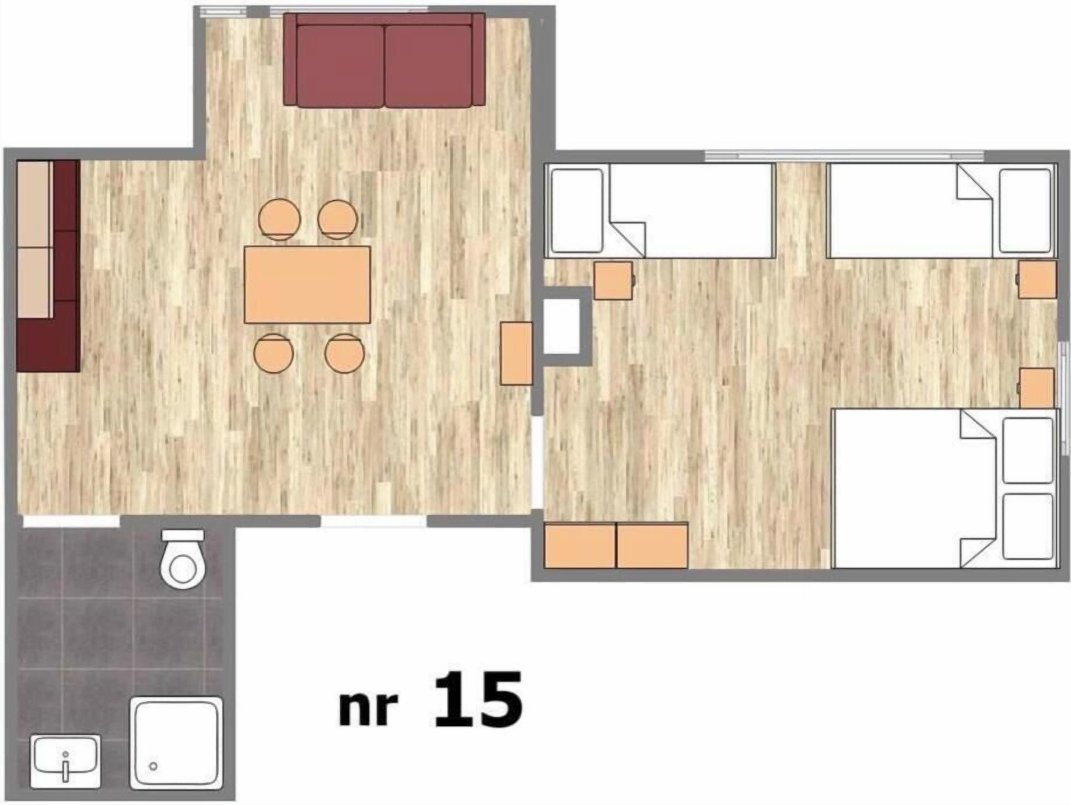 A floor plan of a hotel room with a living area, a dining table, a sofa, a kitchen, and a bathroom.