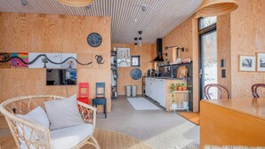 A modern interior with a kitchen, dining area, and seating.