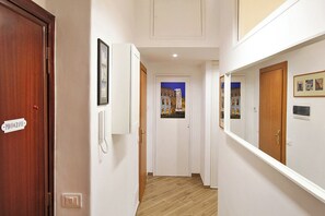 A hallway with a wooden door labeled 'PHOTOGRAPHY,' a white wall-mounted phone, and framed pictures. - Traditional Roman hospitality, right next to St. Peter’s! (Roma)