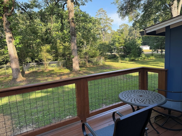 A wooden deck with a metal railing, a round table, and chairs. - Landing Pad, for Rome tennis center, golf course, Berry College, & downtown Rome (Rome)