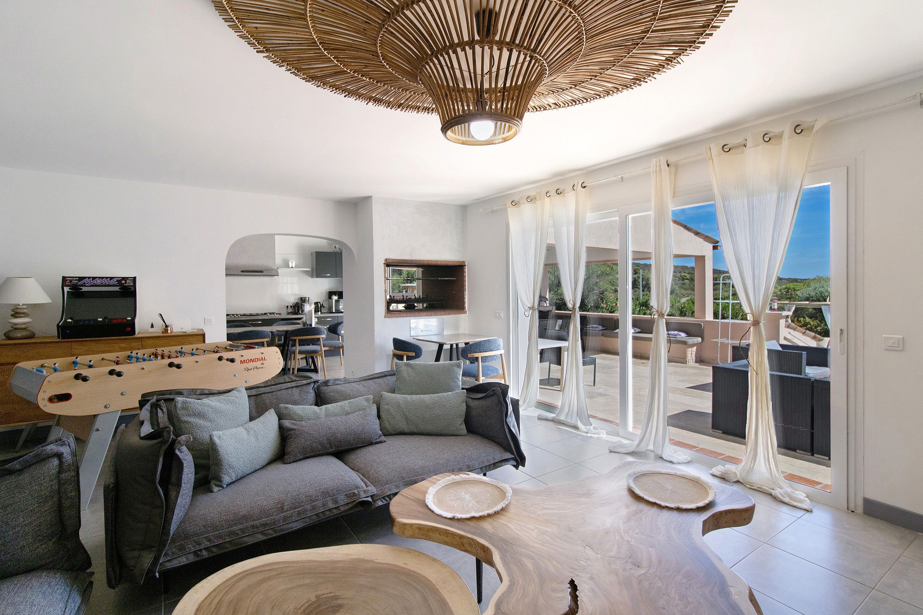 A modern living room with a sofa, coffee table, and a guitar.
