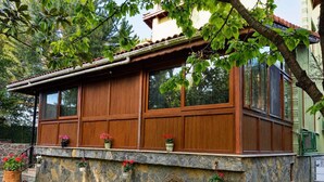 A rustic building with a stone facade, wooden windows, and a large wheel. - Agva Tartaruga Motel (Sile)